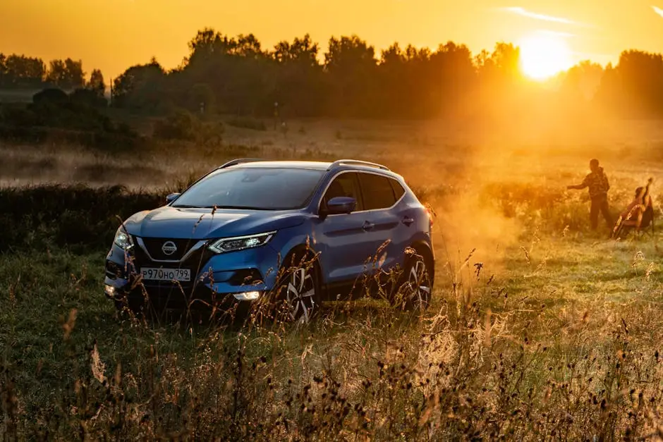 Home Blue SUV in a rural field at sunset with a man and child in the background.